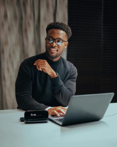 Business professional sitting with laptop and looking left